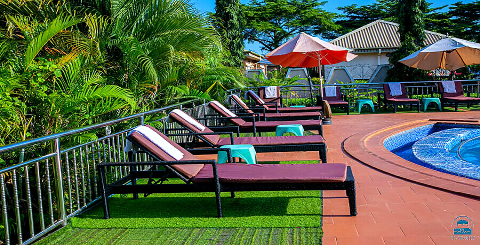 Tropical lounge chairs around the swimming pool